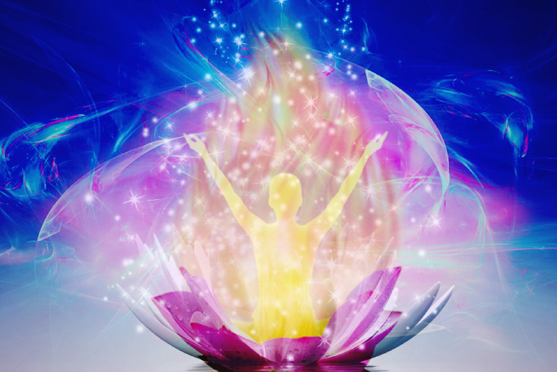 Glowing figure rising from a lotus flower — Holy Fire Karuna Reiki blog post