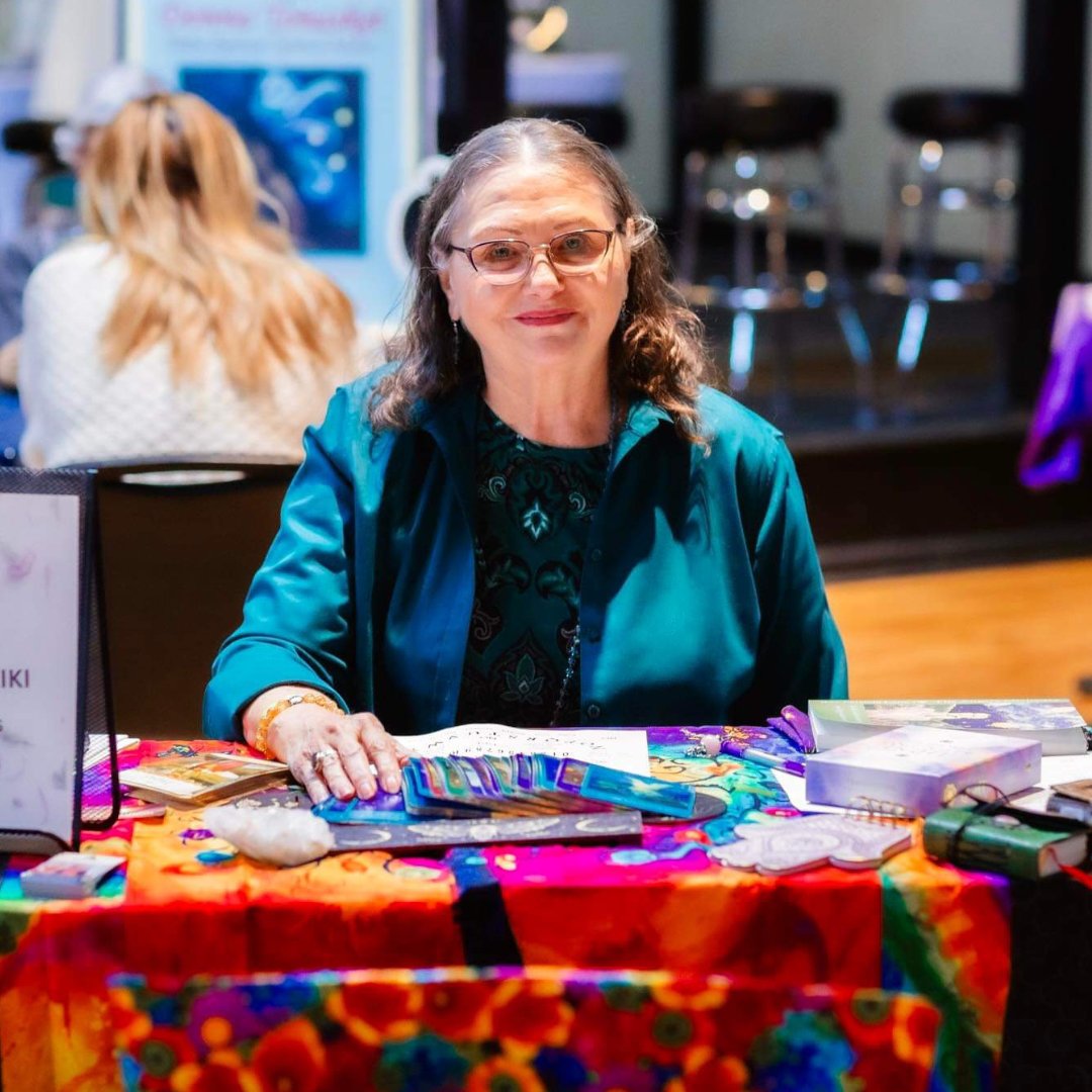 Patricia LaDale Lane at a Reiki and healing arts vendor table